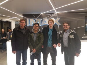 “Cemcorp engineers attending National Engineering Month event at IMAX headquarters in Mississauga, standing in front of the illuminated IMAX sign.